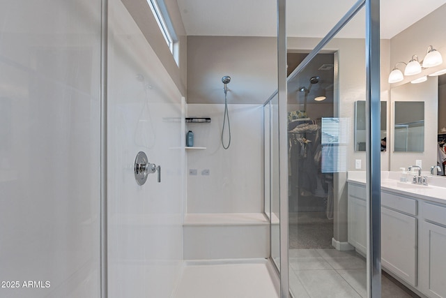 bathroom with a shower, vanity, and tile patterned floors