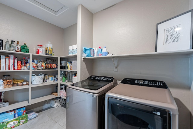 laundry room with separate washer and dryer and light tile patterned floors