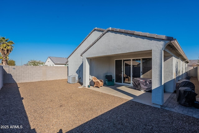 rear view of property featuring central air condition unit and a patio area