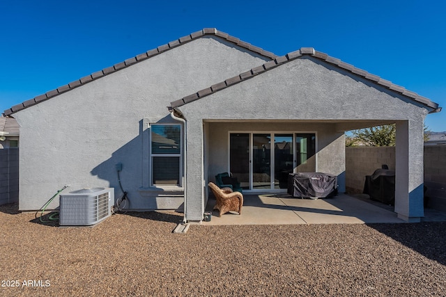 rear view of property with a patio area and cooling unit