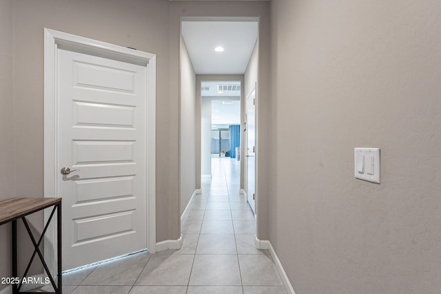 hall with light tile patterned floors