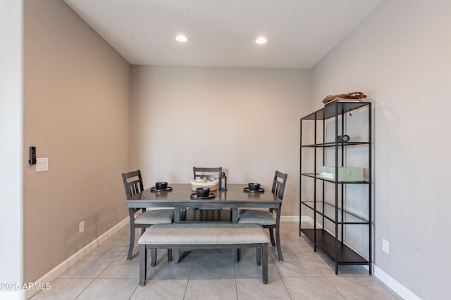 dining space featuring light tile patterned flooring