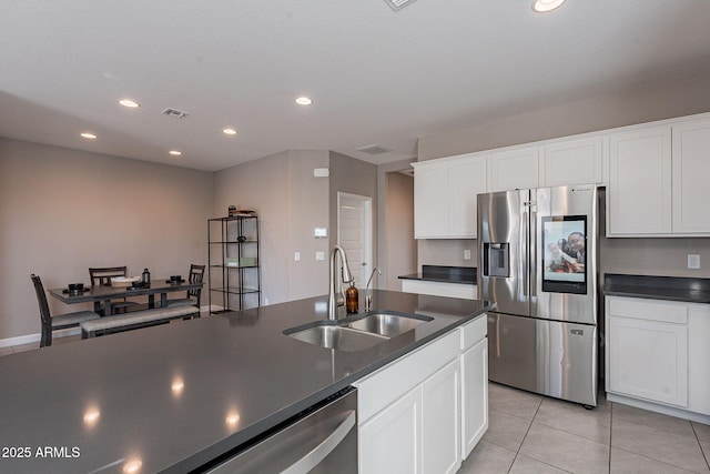 kitchen with appliances with stainless steel finishes, white cabinetry, and sink