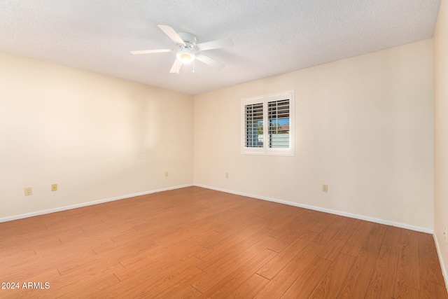 spare room featuring ceiling fan, a textured ceiling, and light wood-type flooring