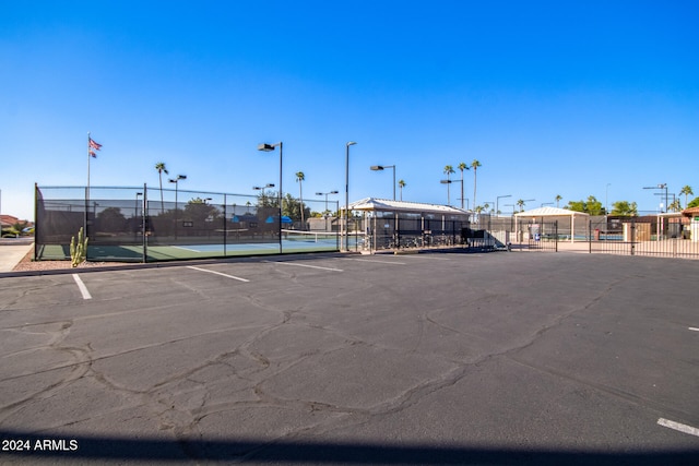 view of parking featuring tennis court