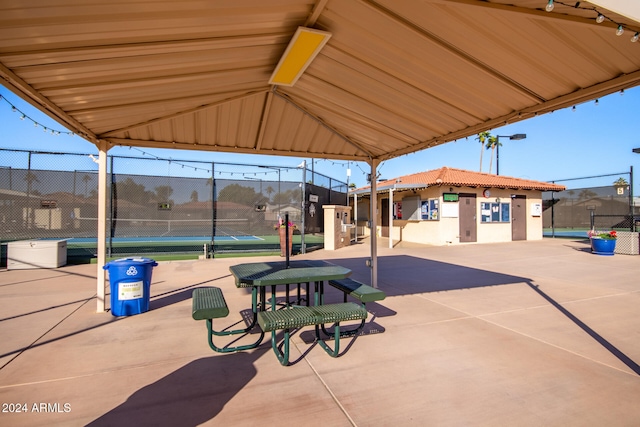 view of patio with a gazebo and tennis court