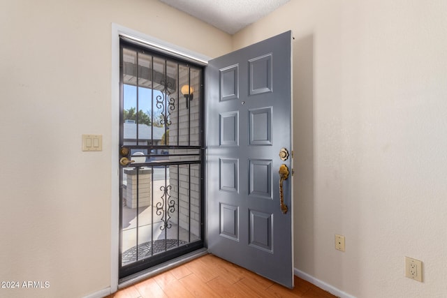 entrance foyer with wood-type flooring and a textured ceiling