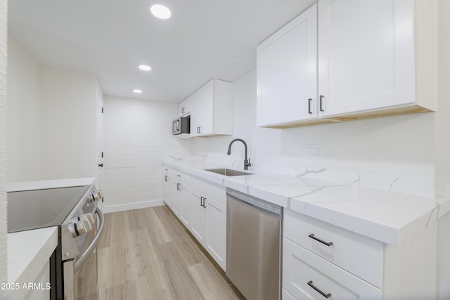 948 S Alma School Rd Unit 1, Mesa, AZ 85210 - kitchen featuring stainless steel appliances, light stone counters, light wood-style floors, white cabinets, and recessed lighting