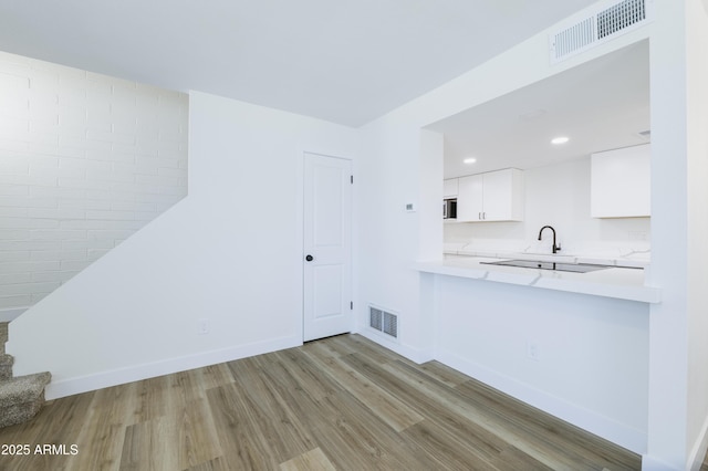 948 S Alma School Rd Unit 1, Mesa, AZ 85210 - unfurnished living room with wood finished floors, recessed lighting, and stairs