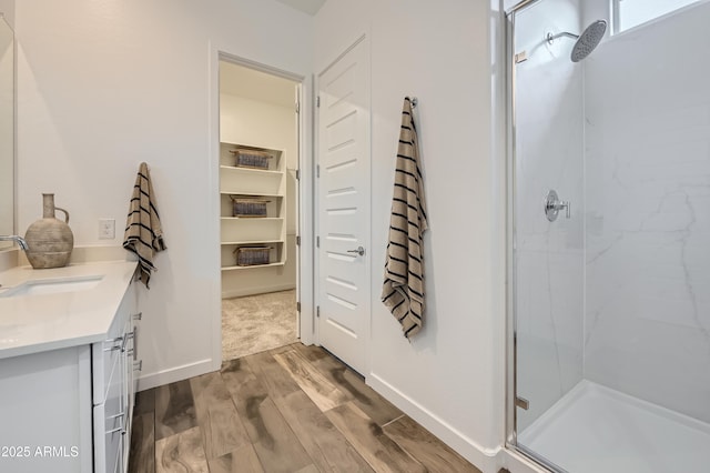 23032 E Roundup Way, Queen Creek, AZ 85142 - full bath with a stall shower, wood finished floors, and double vanity