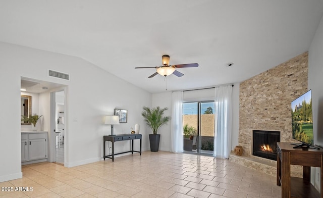 living room featuring a fireplace, visible vents, a ceiling fan, light tile patterned flooring, and vaulted ceiling