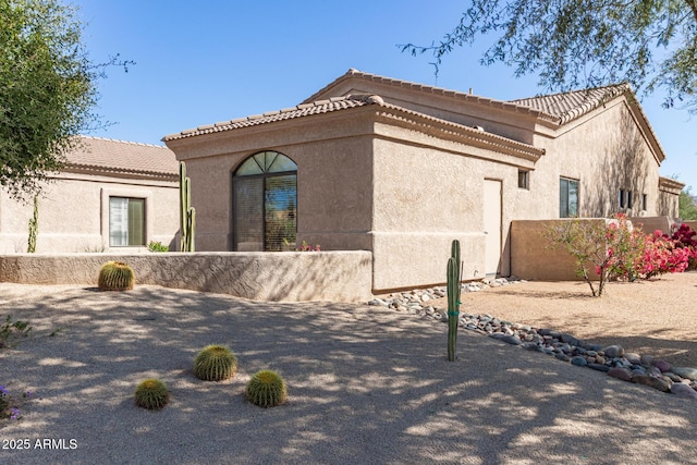 view of home's exterior featuring fence and stucco siding