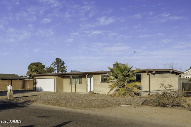 view of front of home featuring brick siding, a garage, and fence