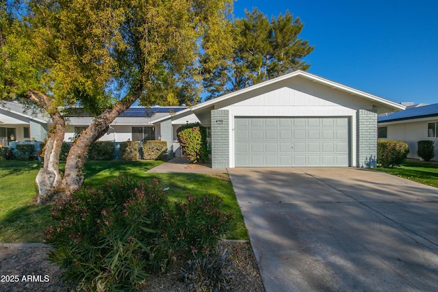 ranch-style house featuring a garage and a front lawn