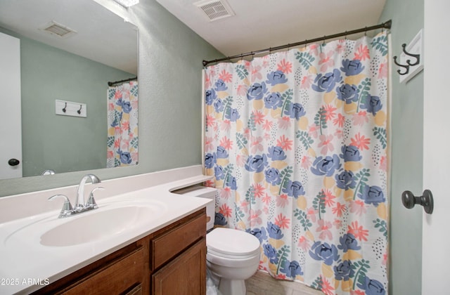 bathroom with vanity, toilet, and walk in shower