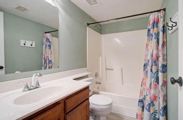 full bathroom with vanity, toilet, and shower / tub combo with curtain