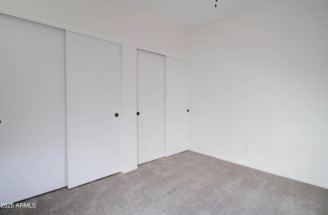 unfurnished bedroom featuring light colored carpet