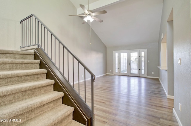 interior space featuring hardwood / wood-style floors, ceiling fan, high vaulted ceiling, and french doors