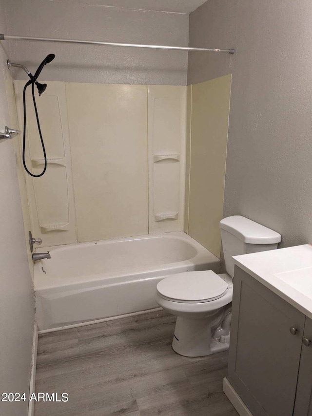 full bathroom with wood-type flooring, vanity, toilet, and shower / tub combination