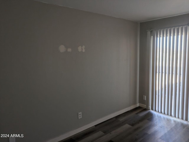 unfurnished room featuring dark wood-type flooring