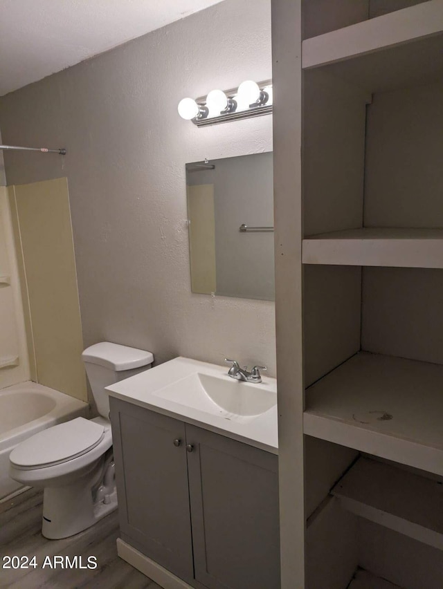 full bathroom featuring toilet, vanity, and bathing tub / shower combination