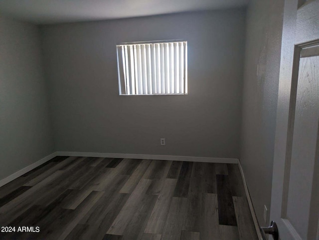 unfurnished room with dark hardwood / wood-style floors