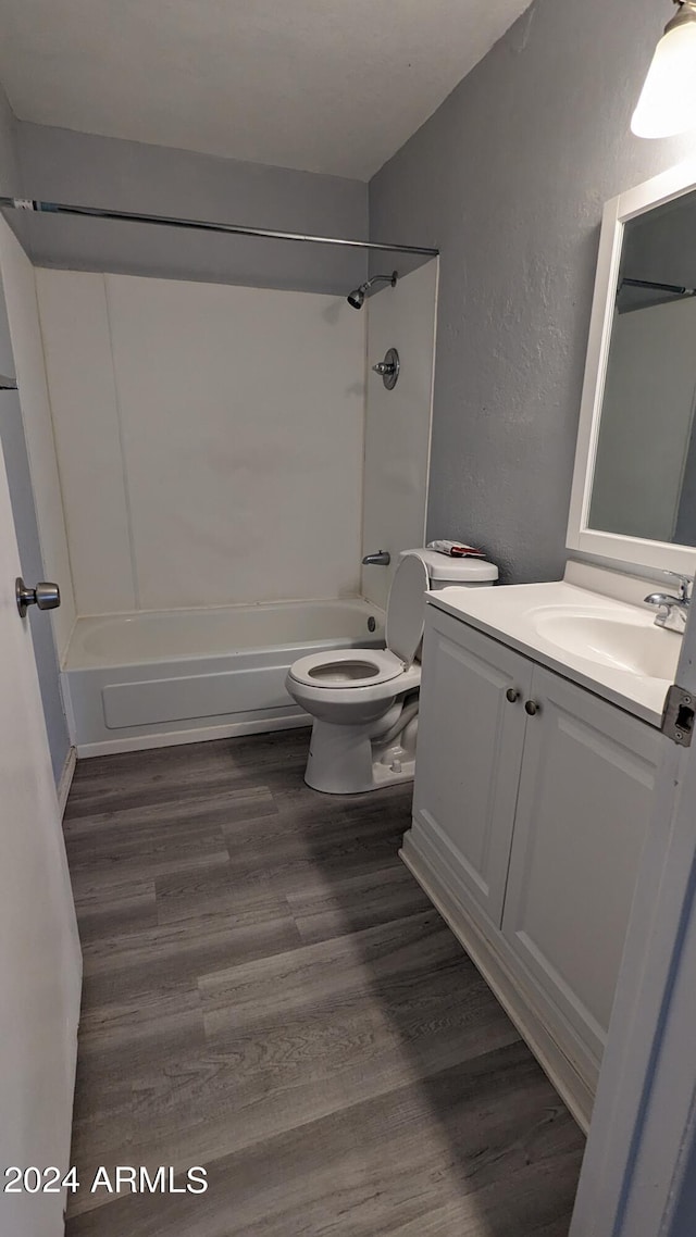 full bathroom featuring toilet, shower / tub combination, vanity, and wood-type flooring