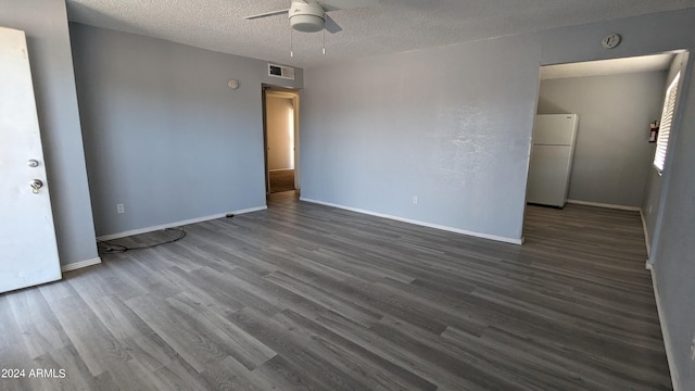 unfurnished room featuring ceiling fan, a textured ceiling, and dark hardwood / wood-style floors