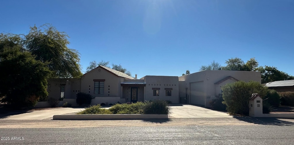 pueblo revival-style home with a garage