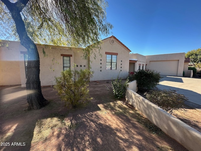 pueblo revival-style home with a garage