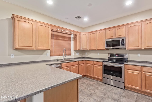 kitchen featuring light tile patterned floors, sink, light brown cabinets, and appliances with stainless steel finishes