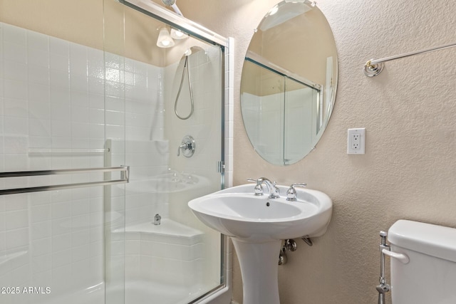 bathroom with toilet and walk in shower