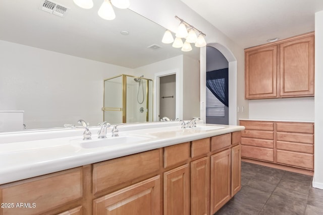 bathroom with vanity, a shower with shower door, and tile patterned flooring