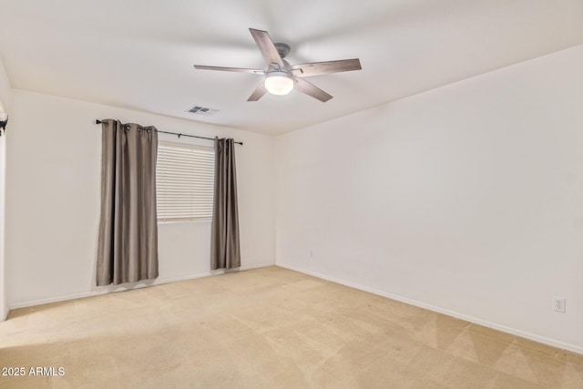 carpeted spare room with ceiling fan