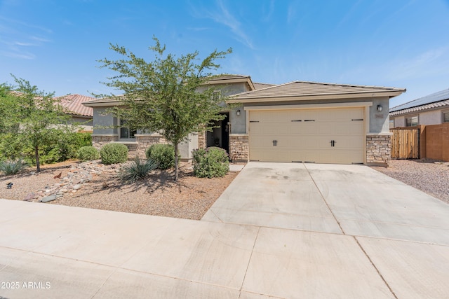 26032 W Quail Ave, Buckeye, AZ 85396 - view of front of home with stone siding, driveway, stucco siding, and an attached garage