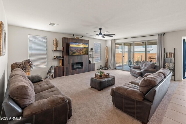 26032 W Quail Ave, Buckeye, AZ 85396 - living room featuring a ceiling fan and a glass covered fireplace