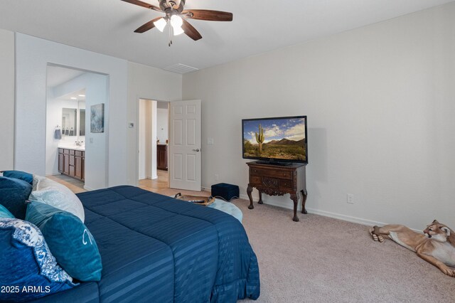 26032 W Quail Ave, Buckeye, AZ 85396 - bedroom featuring light carpet, baseboards, connected bathroom, and ceiling fan