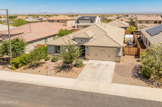 26032 W Quail Ave, Buckeye, AZ 85396 - view of front facade with a residential view, stone siding, an attached garage, driveway, and a tiled roof