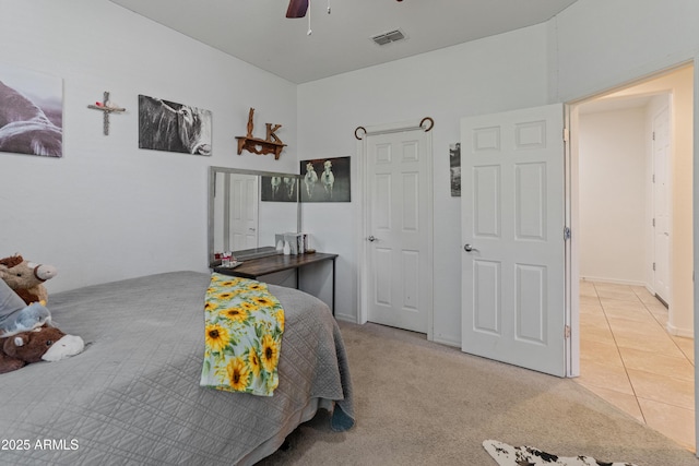 26032 W Quail Ave, Buckeye, AZ 85396 - bedroom featuring light tile patterned floors, a ceiling fan, and light carpet