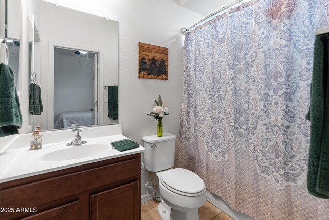 26032 W Quail Ave, Buckeye, AZ 85396 - bathroom featuring vanity, toilet, tile patterned floors, a shower with shower curtain, and ensuite bathroom