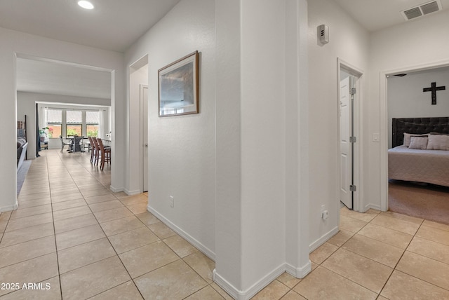 26032 W Quail Ave, Buckeye, AZ 85396 - hallway with light tile patterned floors, baseboards, and recessed lighting