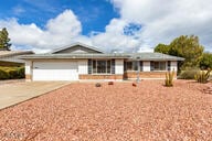 ranch-style house featuring a garage and driveway