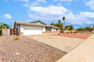 ranch-style home featuring a garage and concrete driveway