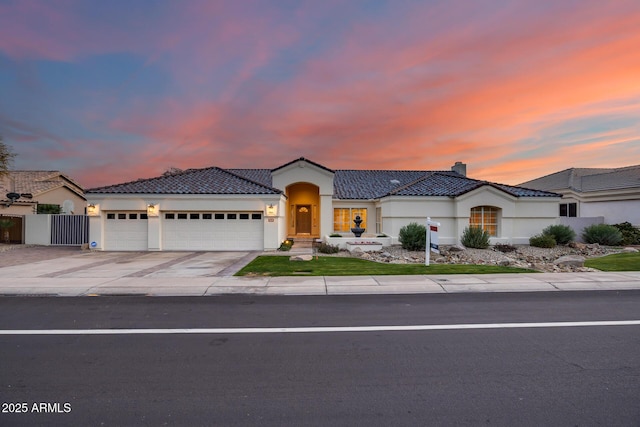 mediterranean / spanish home with a garage