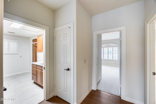 hall with hardwood / wood-style flooring