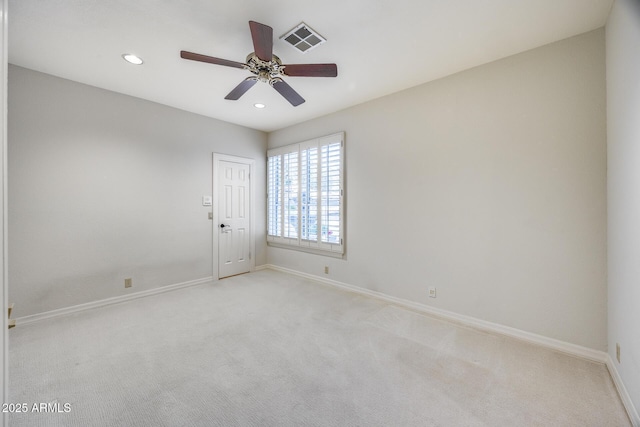 carpeted spare room featuring ceiling fan