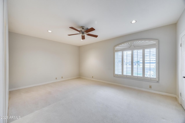 unfurnished room with ceiling fan and light colored carpet