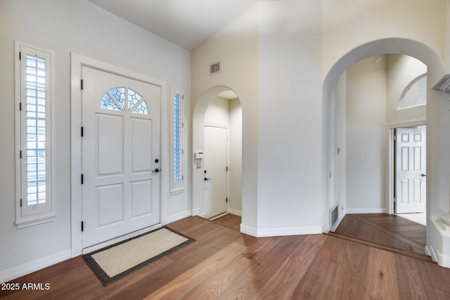 foyer entrance featuring a high ceiling and light hardwood / wood-style floors