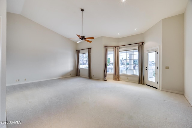 spare room with high vaulted ceiling, light colored carpet, and ceiling fan