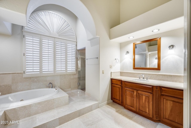 bathroom featuring vanity and shower with separate bathtub